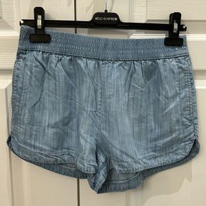 Aritzia TNA elastic waist jean shorts.